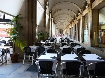 an empty hallway with tables and chairs in a restaurant at Roma Reial in Barcelona