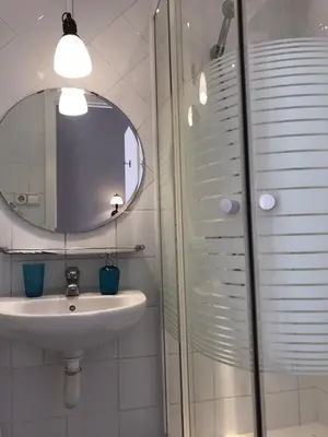 a bathroom with a sink and a mirror at Casa Consell Gran Via, Guest House in Barcelona