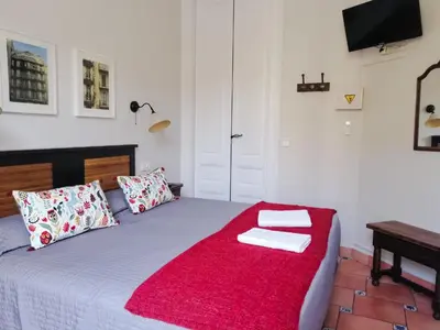a bedroom with a bed with two towels on it at Casa Consell Gran Via, Guest House in Barcelona