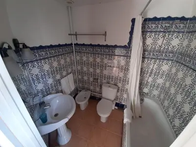 a bathroom with a sink and a toilet and a shower at Casa Consell Gran Via, Guest House in Barcelona