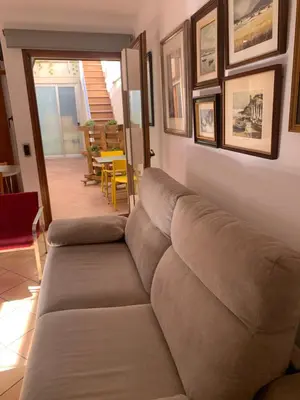 a couch sitting in a living room with a table at Chic apartment beach in Mataró