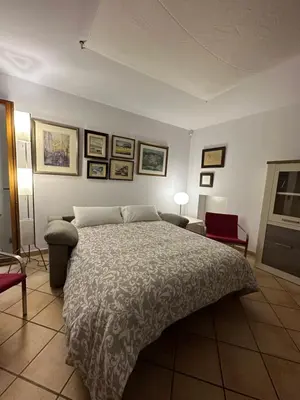 a bedroom with a large bed and pictures on the wall at Chic apartment beach in Mataró