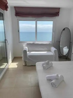 a bedroom with two beds and a large window at Villa Farell just in front of the sea in San Pol de Mar