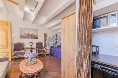a living room with a bed and a table at El Petit Palauet in Canet de Mar