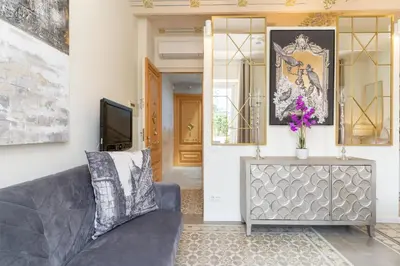 a living room with a couch and a tv at El Petit Palauet in Canet de Mar