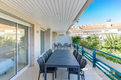 a patio with chairs and tables on a balcony at Apt Parc Del Mar in Sitges very near Beach in Sitges