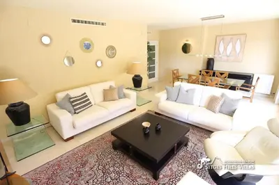 a living room with white furniture and a large window at Apt Parc Del Mar in Sitges very near Beach in Sitges