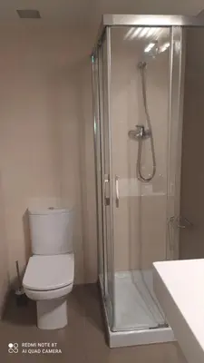 a bathroom with a toilet and a glass shower at Studio doria in Sant Boi del Llobregat