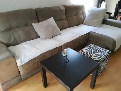 a couch with pillows and a table in a living room at 3 BEDROOMS, 2 BATHROOMS FOR 6 PAX, SWIMMING POOL, FREE PARKING and NEAR THE BEACH! in Sant Adria de Besos