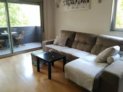 a living room with a couch and a table at 3 BEDROOMS, 2 BATHROOMS FOR 6 PAX, SWIMMING POOL, FREE PARKING and NEAR THE BEACH! in Sant Adria de Besos