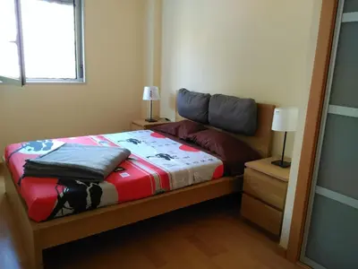 a bedroom with a bed in a room with a window at 3 BEDROOMS, 2 BATHROOMS FOR 6 PAX, SWIMMING POOL, FREE PARKING and NEAR THE BEACH! in Sant Adria de Besos