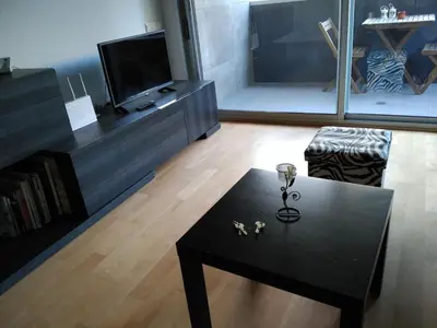 a living room with a black coffee table and a tv at 3 BEDROOMS, 2 BATHROOMS FOR 6 PAX, SWIMMING POOL, FREE PARKING and NEAR THE BEACH! in Sant Adria de Besos