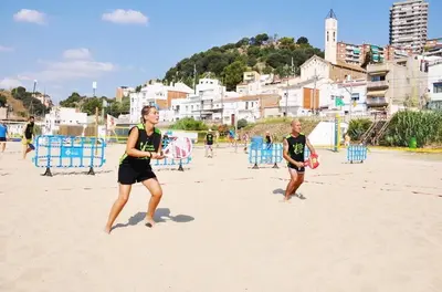 two women playing a game of frisbee on the beach at EMILY BEACH-CITY Apartment in Montgat