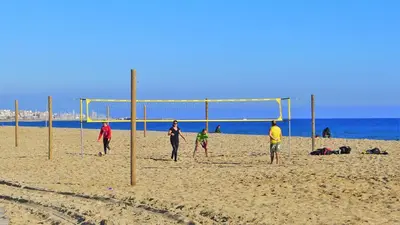 a group of people playing soccer on the beach at EMILY BEACH-CITY Apartment in Montgat