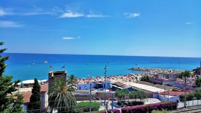 a beach with a lot of people and the ocean at EMILY BEACH-CITY Apartment in Montgat