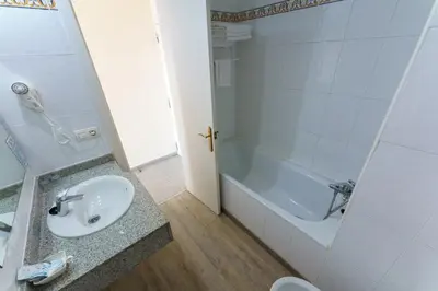 a bathroom with a sink and a bath tub at Checkin Catalonia in Calella