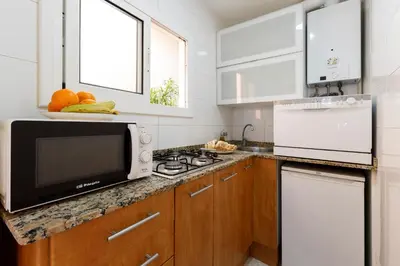 a kitchen with a microwave and a counter top at Barcelona Sunny Terrace in Hospitalet de Llobregat