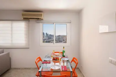 a table and chairs in a room with a window at Barcelona Sunny Terrace in Hospitalet de Llobregat