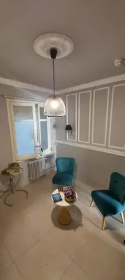 a living room with two chairs and a table at AinB B&B Eixample-Muntaner in Barcelona