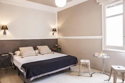 a bedroom with a bed and a window at AinB B&B Eixample-Muntaner in Barcelona