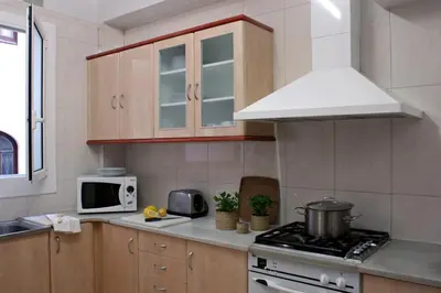 a kitchen with a stove and a microwave at AinB B&B Eixample-Muntaner in Barcelona