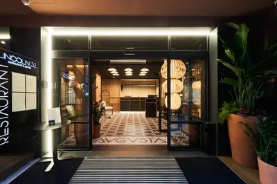 an entrance to a building with a lobby with plants at Aparthotel Augusta in Barcelona