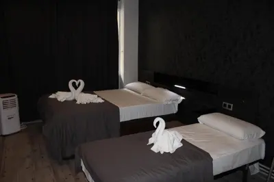 a room with three beds with swans on them at BCN Condal Hostal in Barcelona
