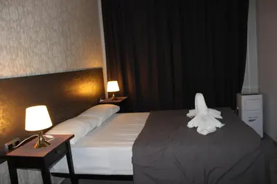 a hotel room with a bed with a towel on it at BCN Condal Hostal in Barcelona