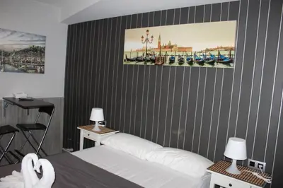 a bedroom with a bed and a desk with a chair at BCN Condal Hostal in Barcelona
