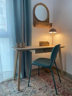 a desk with a chair and a mirror and a lamp at Penthouse in Historic Sitges -Big Terrace & Private Solarium in Sitges