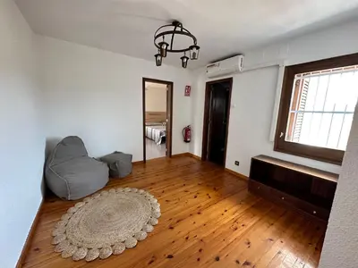 an empty living room with a couch and a window at Casa L'Avi in Palau-Solità i Plegamans