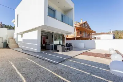 a white house with a lot of windows at Exclusiva Villa de Lujo con piscina in Canyelles