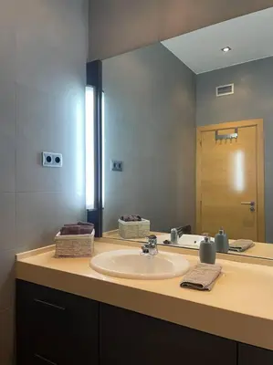a bathroom with a sink and a large mirror at Exclusiva Villa de Lujo con piscina in Canyelles