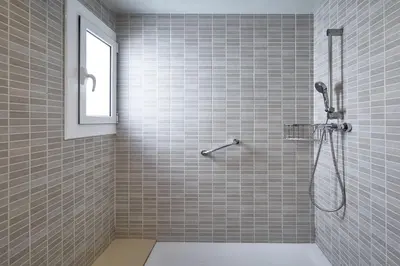 a bathroom with a shower with a window at BBarcelona Montjuic Apartment in Barcelona