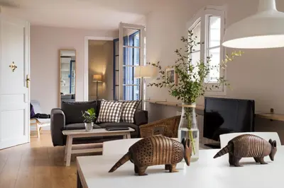 a living room with a table with two wooden rats on it at Bed&BCN Diagonal 4 in Barcelona