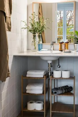 a bathroom with a sink and a mirror and towels at Bed&BCN Diagonal 4 in Barcelona