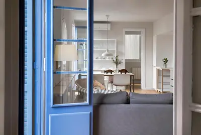 a living room with a couch and a dining room at Bed&BCN Diagonal 4 in Barcelona