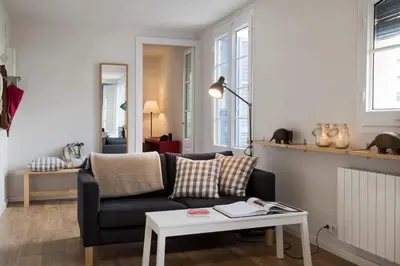 a living room with a couch and a table at Bed&BCN Diagonal 5 in Barcelona