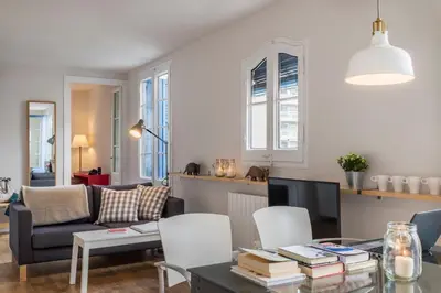 a living room with a couch and a table at Bed&BCN Diagonal 5 in Barcelona