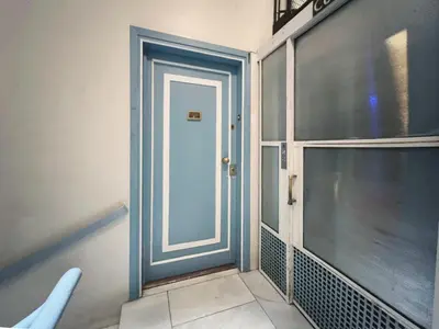 a blue door in a room with a window at Stay U-nique Apartment Passeig de Gràcia III in Barcelona