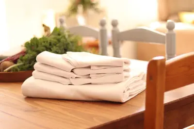 a pile of white towels sitting on a table at Mas Cal Gira in Moià