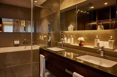 a bathroom with two sinks and a large mirror at Grand Hotel Central, Small Luxury Hotels in Barcelona