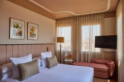 a hotel room with a bed and a television at Grand Hotel Central, Small Luxury Hotels in Barcelona