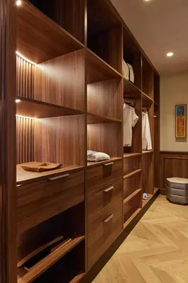 a walk in closet with wooden cabinets at Grand Hotel Central, Small Luxury Hotels in Barcelona