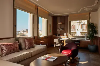 a living room with a couch and a table at Grand Hotel Central, Small Luxury Hotels in Barcelona