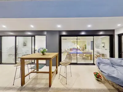 a living room with a table and a couch at Premium Habitat 3 Hermanas in Sant Andreu de Llavaneres