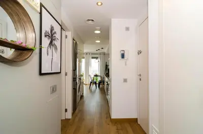 a hallway of a home with white walls and wood floors at Sitges Spaces Sea View Oasis in Sitges