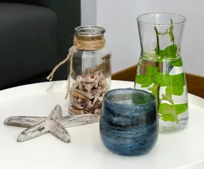 a table with starfish and a jar and a vase at Sitges Spaces Sea View Oasis in Sitges