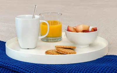 a plate with a glass of orange juice and a bowl of fruit at Sitges Spaces Sea View Oasis in Sitges