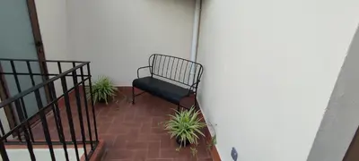 a bench sitting on a porch with some plants at CasaBala - Near the beach and Barcelona center in Badalona